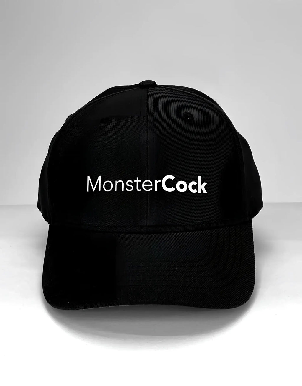 Black baseball cap with "MonsterCock" printed in white, sans-serif font across the front.