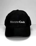 Black baseball cap with "MonsterCock" printed in white, sans-serif font across the front.
