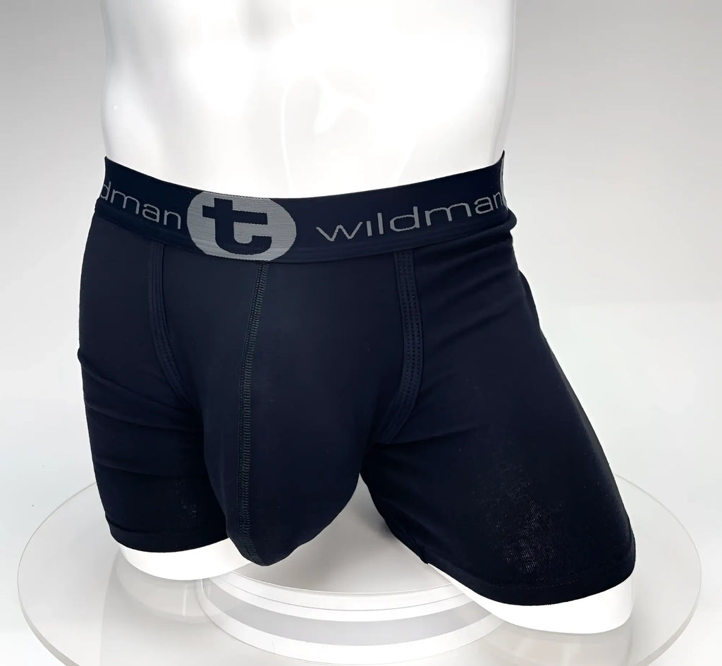 Black boxer briefs on a mannequin with a 5-inch inseam, prominent pouch, and branded "Wildman" elastic waistband.