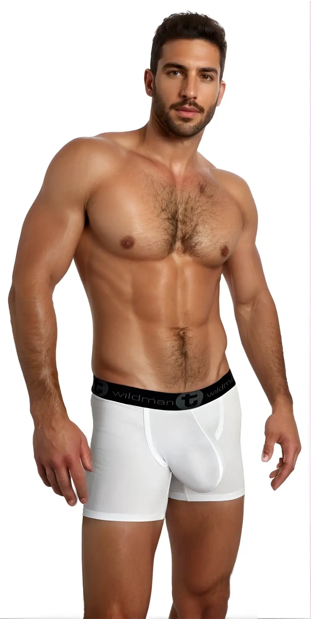 A muscular man wearing white Wildman Big Boy boxer briefs with a prominent pouch and black logo waistband.