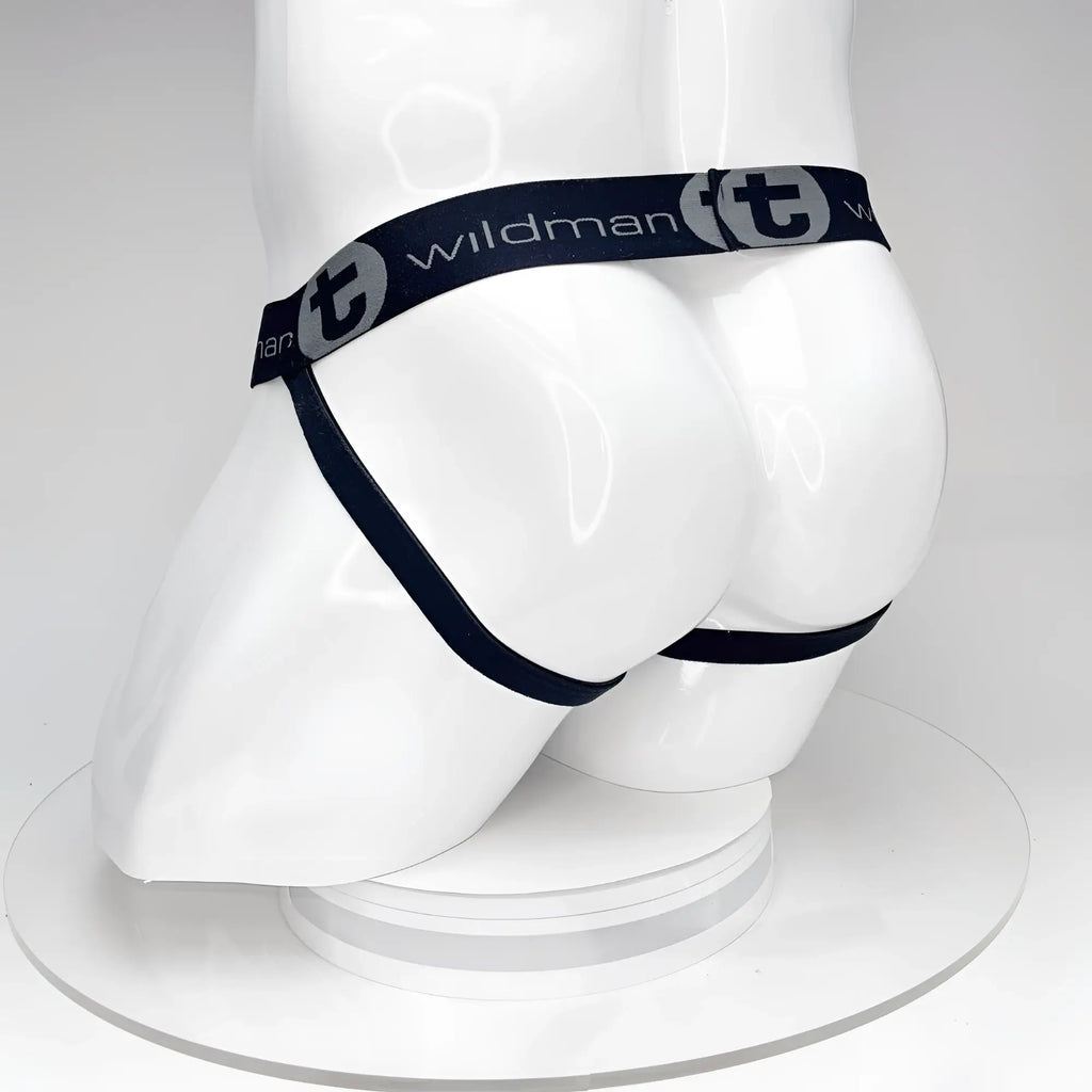 Black WildmanT jockstrap on a white mannequin, featuring a branded elastic waistband with logo text and side straps.