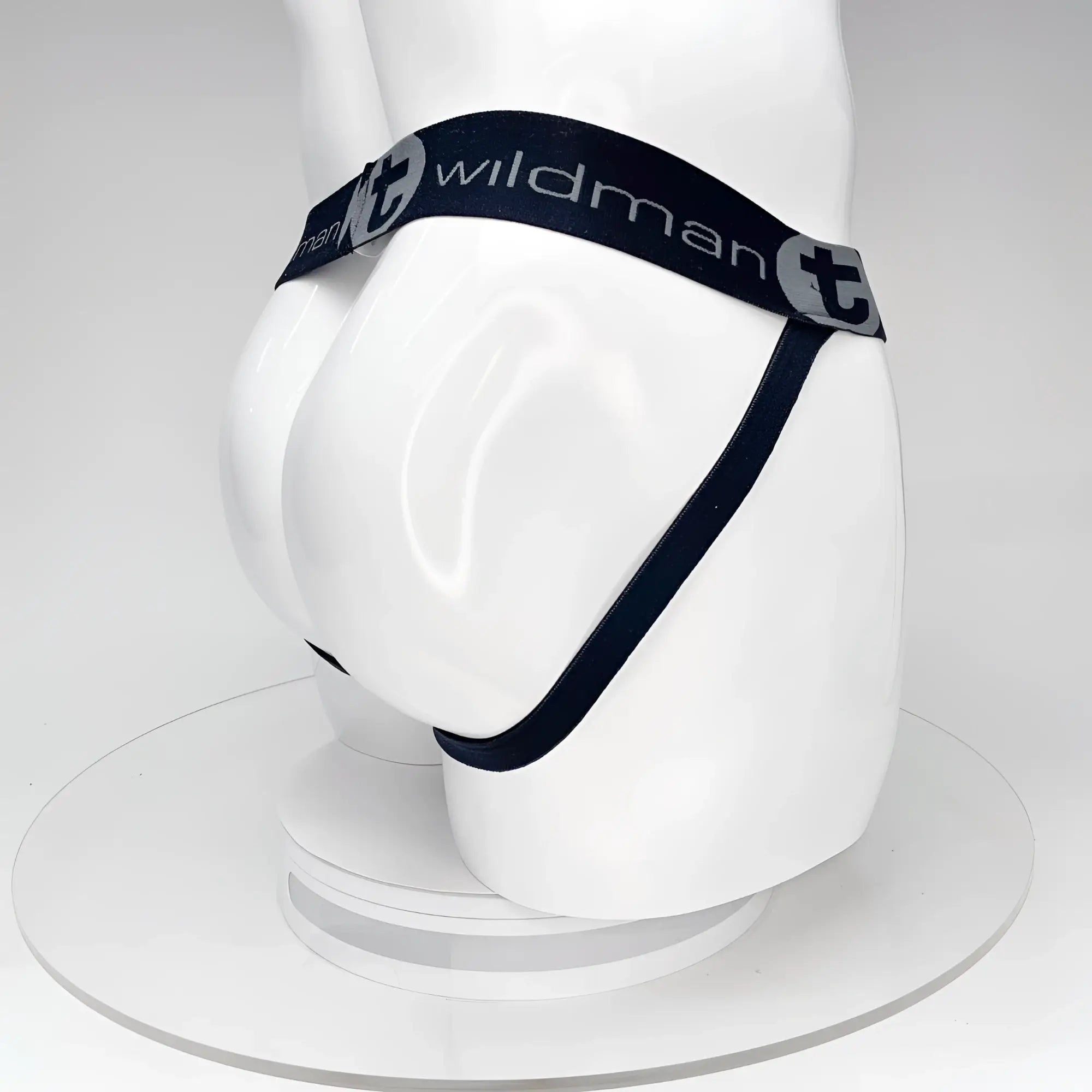 Black WildmanT jockstrap on a white mannequin, featuring a branded elastic waistband and rear strap design.