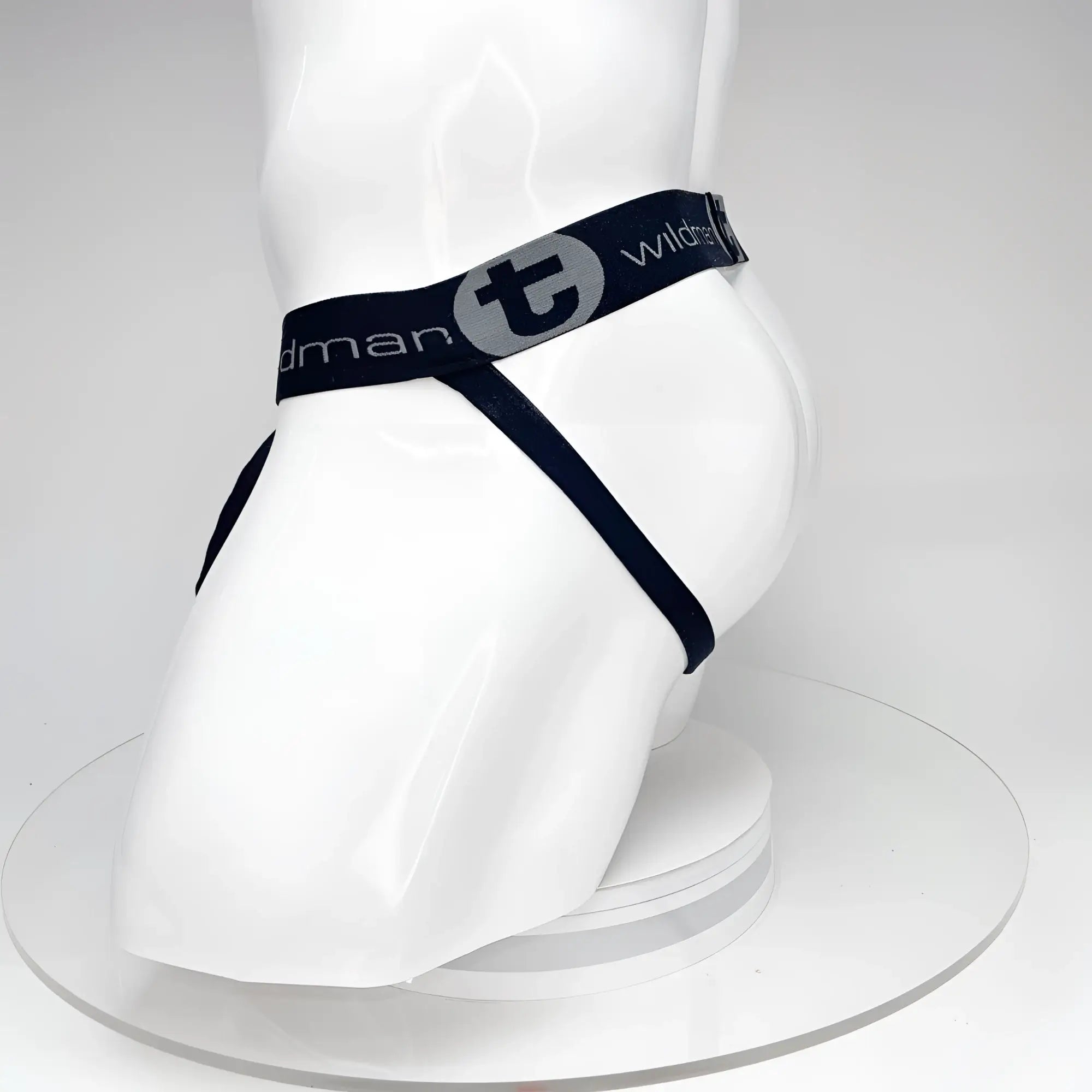 Black WildmanT jockstrap on a white mannequin, featuring a branded elastic waistband with a "t" logo.