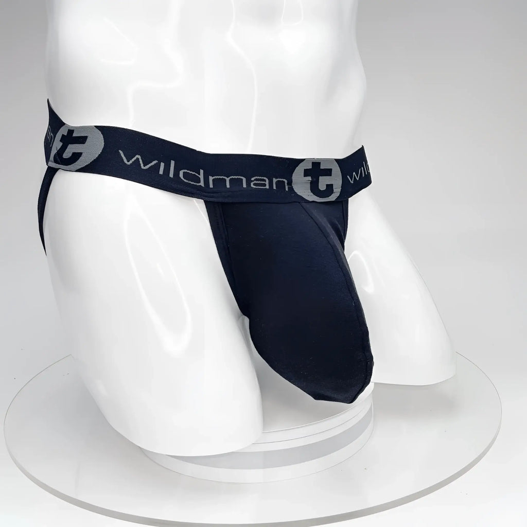 Black WildmanT jockstrap with a large contour pouch and branded elastic waistband on a white mannequin torso.