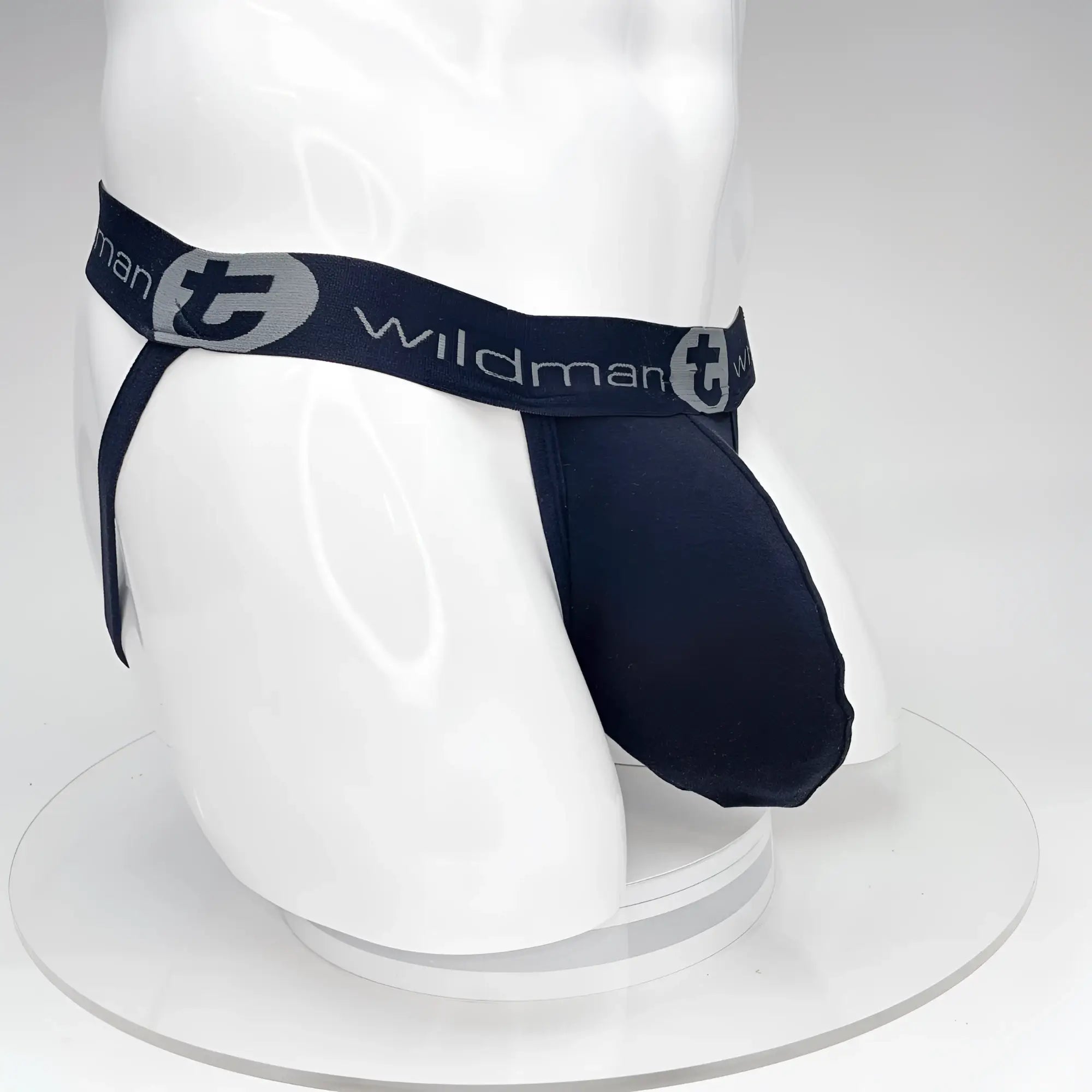 Black jockstrap with a large pouch on a white mannequin, featuring a branded "WildmanT" elastic waistband.