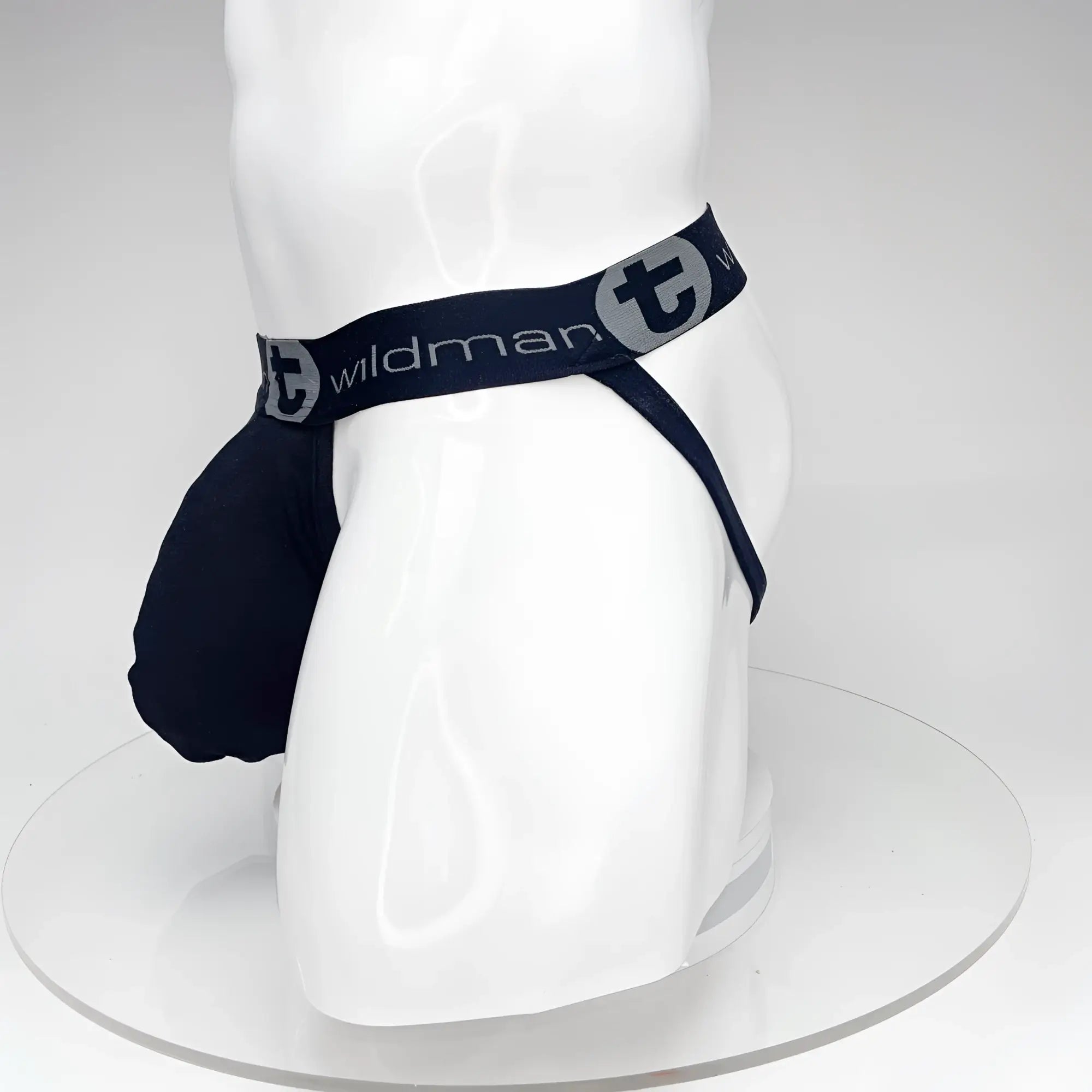 Black WildmanT jockstrap with a large front pouch and logo waistband on a white mannequin.