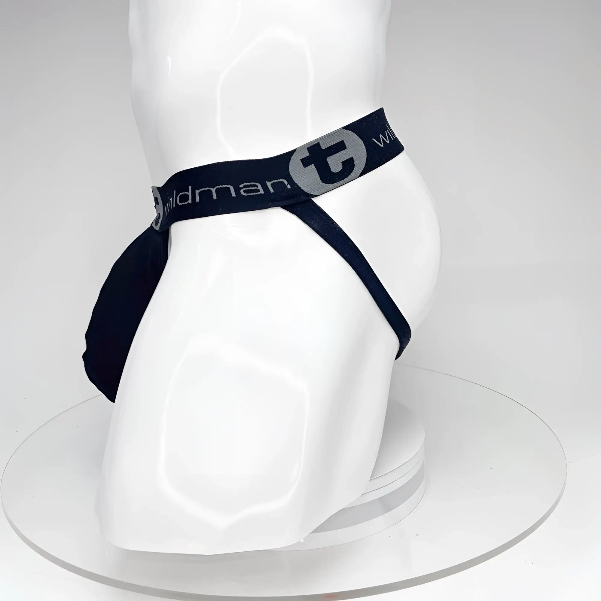 Black WildmanT jockstrap with a pouch and branded elastic waistband on a white mannequin torso.