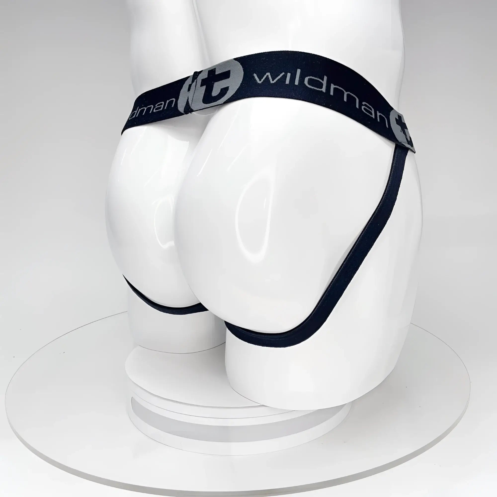 WildmanT black jockstrap on a white mannequin, featuring a branded waistband with grey logo lettering.