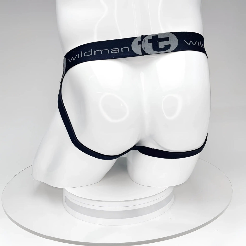 Back view of a black WildmanT jockstrap on a white mannequin, featuring a branded elastic waistband with a "t" logo.