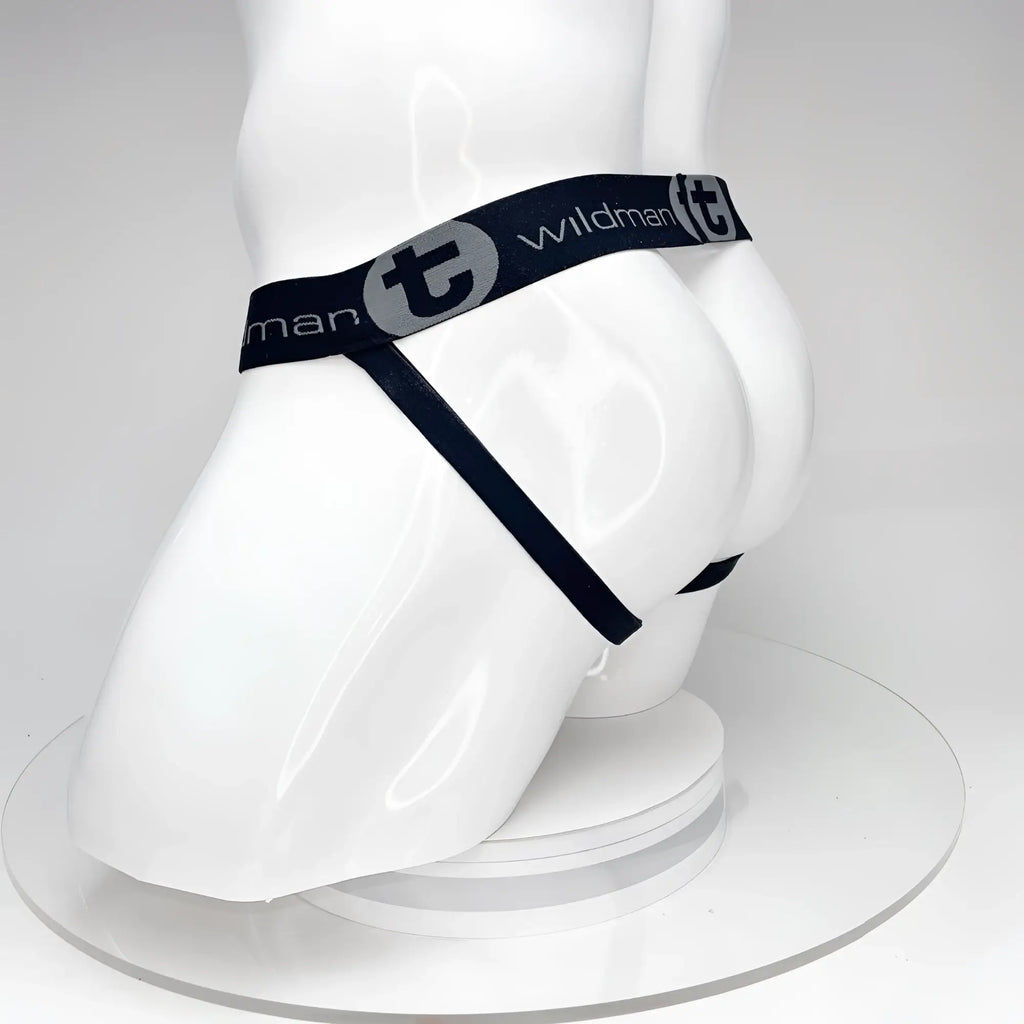 Black WildmanT jockstrap on a white mannequin, featuring a branded elastic waistband with logo text and side straps.