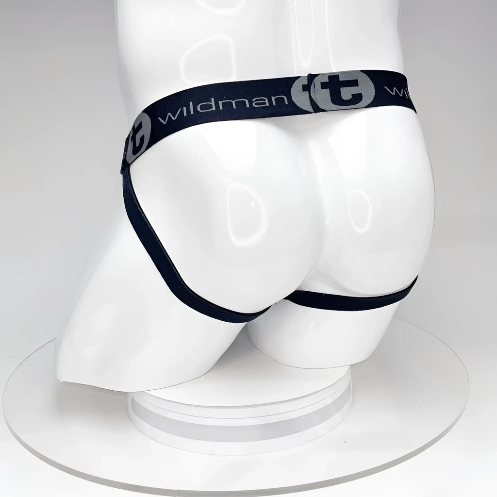 Black WildmanT jockstrap on a white mannequin, featuring a branded elastic waistband with "WildmanT" logo.