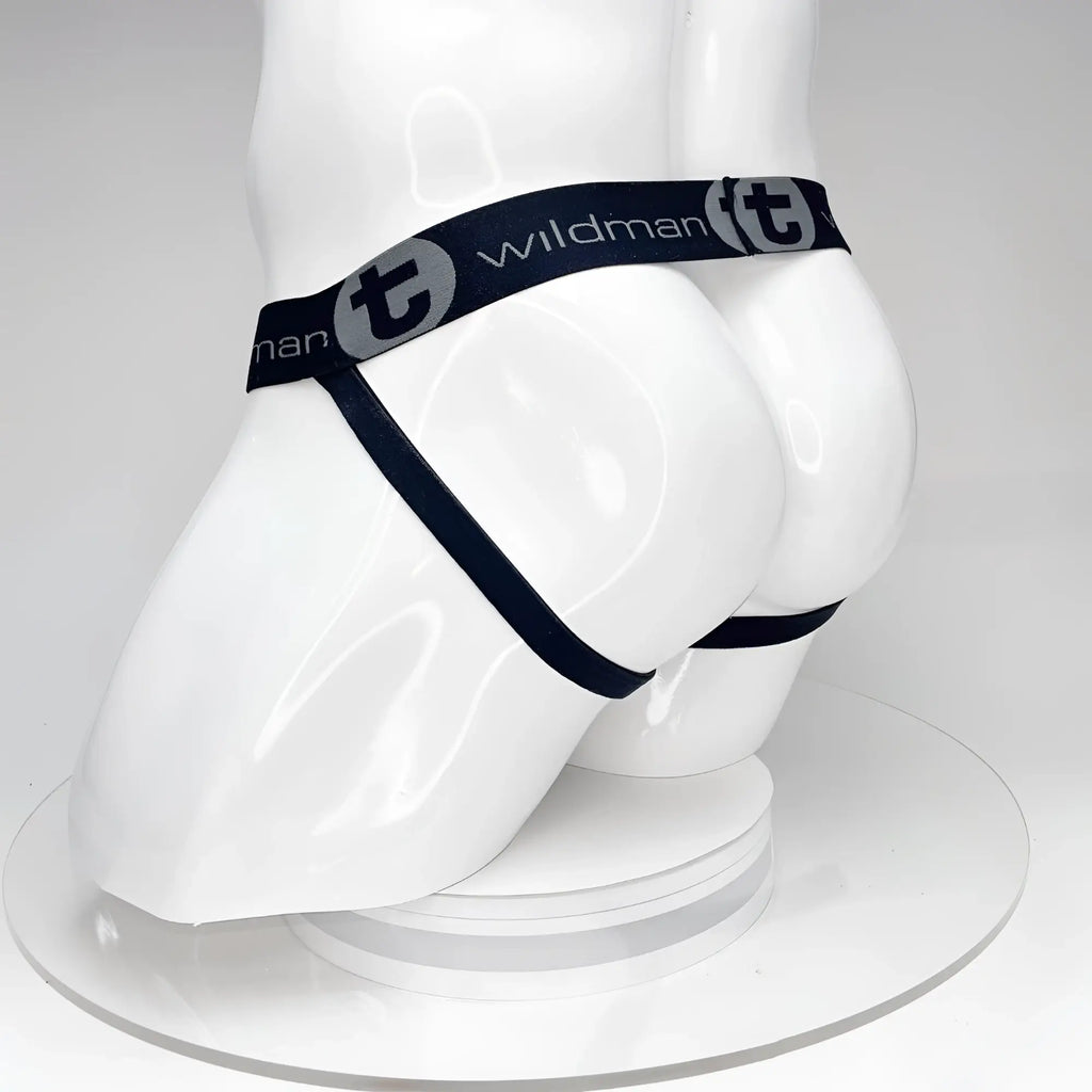Black WildmanT jockstrap on a white mannequin, featuring a branded elastic waistband with logos and thin leg straps.
