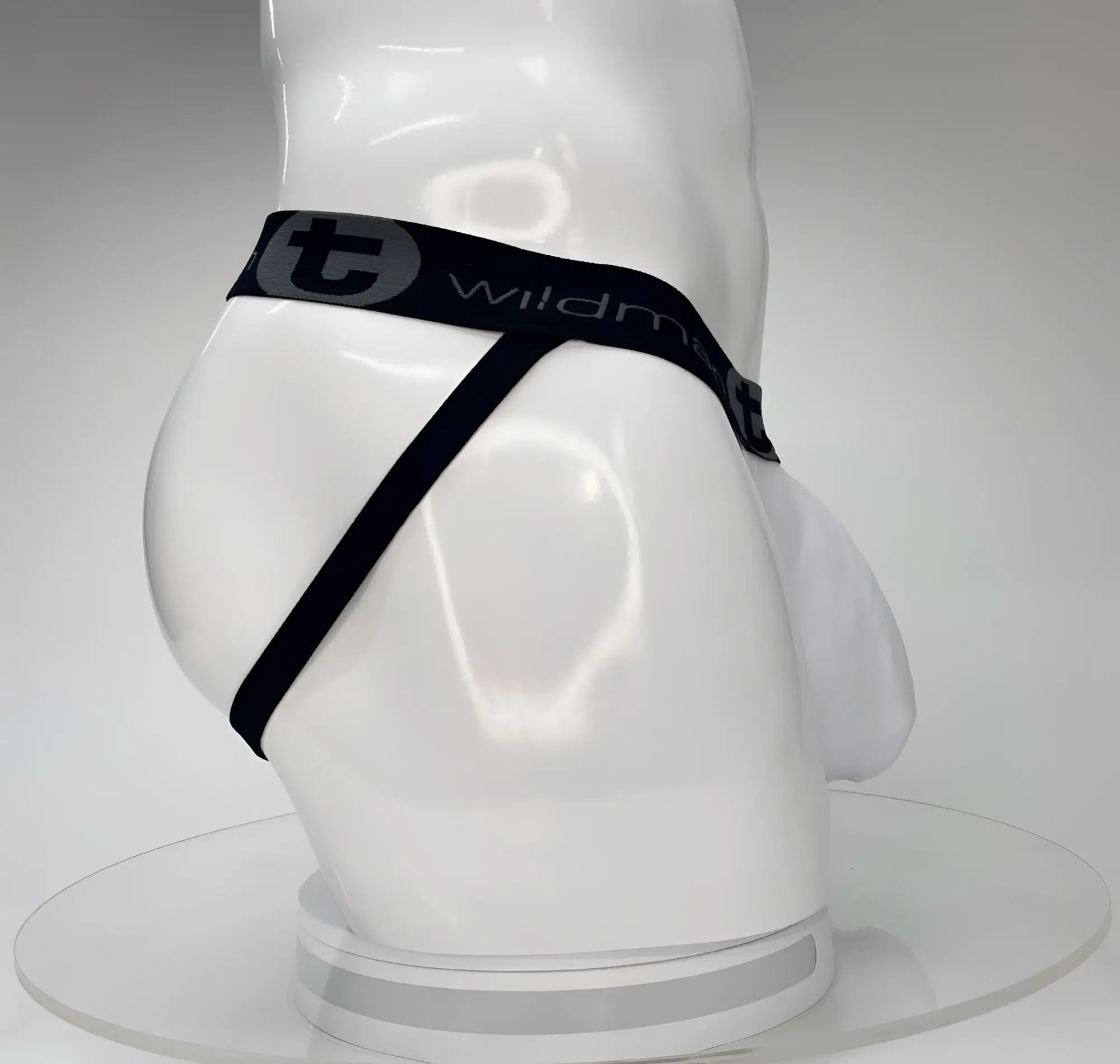 White WildmanT Big Boy Pouch jockstrap on a white mannequin, featuring a black waistband with branded logo.