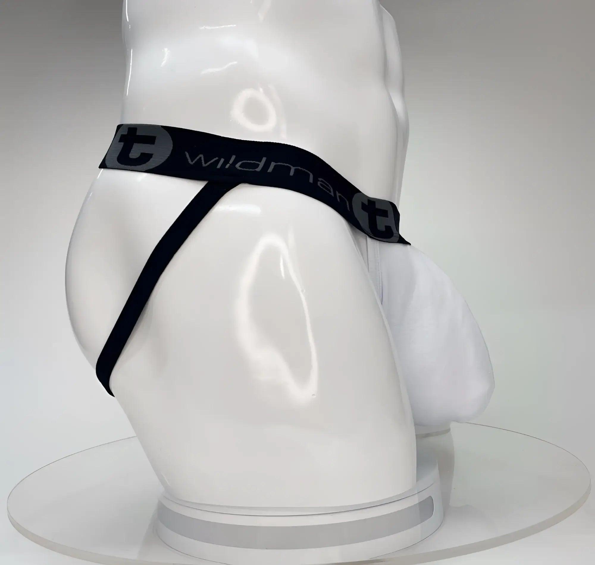 White WildmanT jockstrap with a large front pouch and a black branded waistband on a white mannequin.