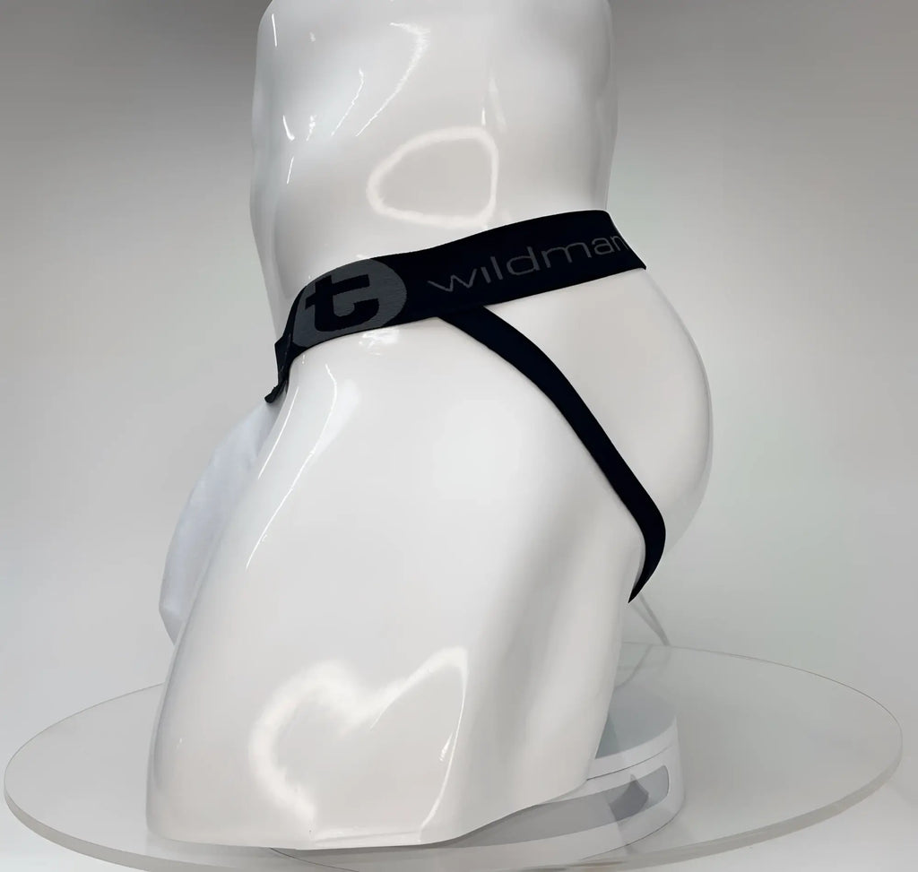 White WildmanT Big Boy pouch jockstrap on a mannequin, featuring a black branded waistband with a circular logo.