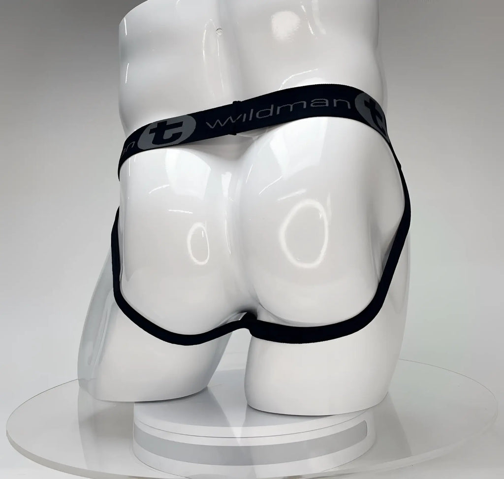 White WildmanT Big Boy jockstrap featuring a black branded elastic waistband on a white mannequin.