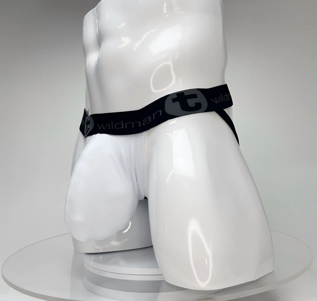 White WildmanT jockstrap with a large front pouch and a black branded elastic waistband on a white mannequin torso.