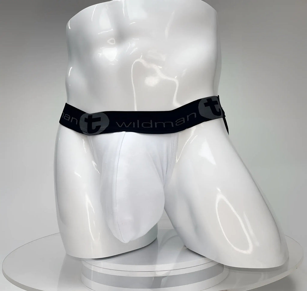 White WildmanT Big Boy pouch jockstrap on a mannequin, featuring a black waistband with WildmanT logo branding.