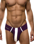 Purple and white modal briefs with a pouch, featuring a vertical white stripe down the center and a Wildman logo tag.