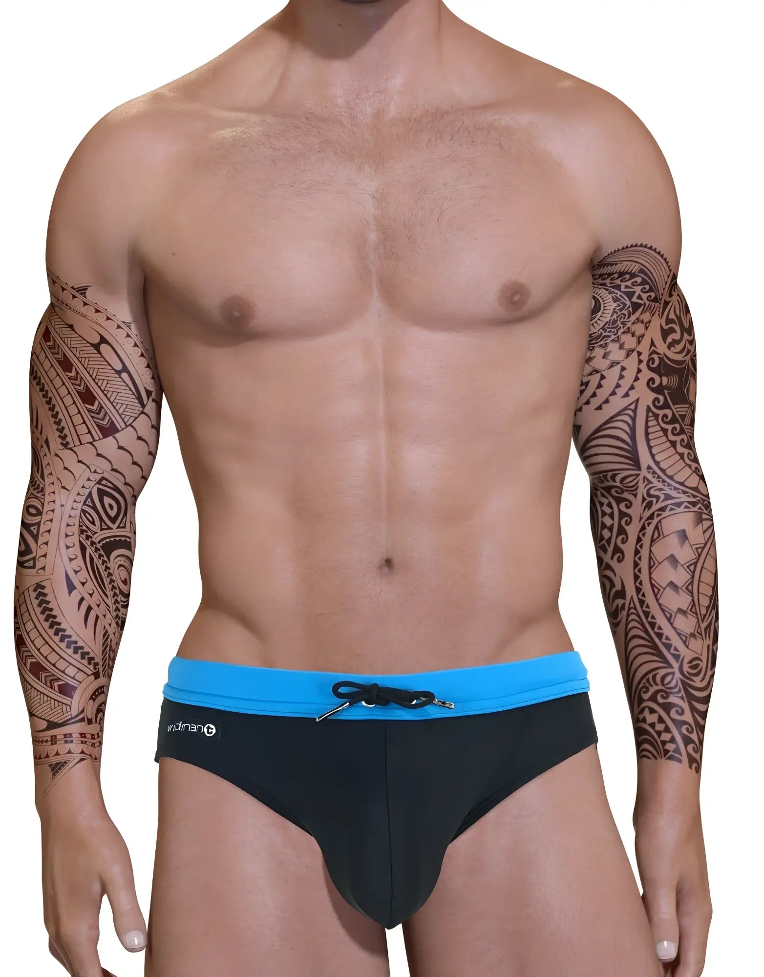 Muscular man with tribal arm tattoos wearing a black swim bikini with a blue waistband and front drawstring.