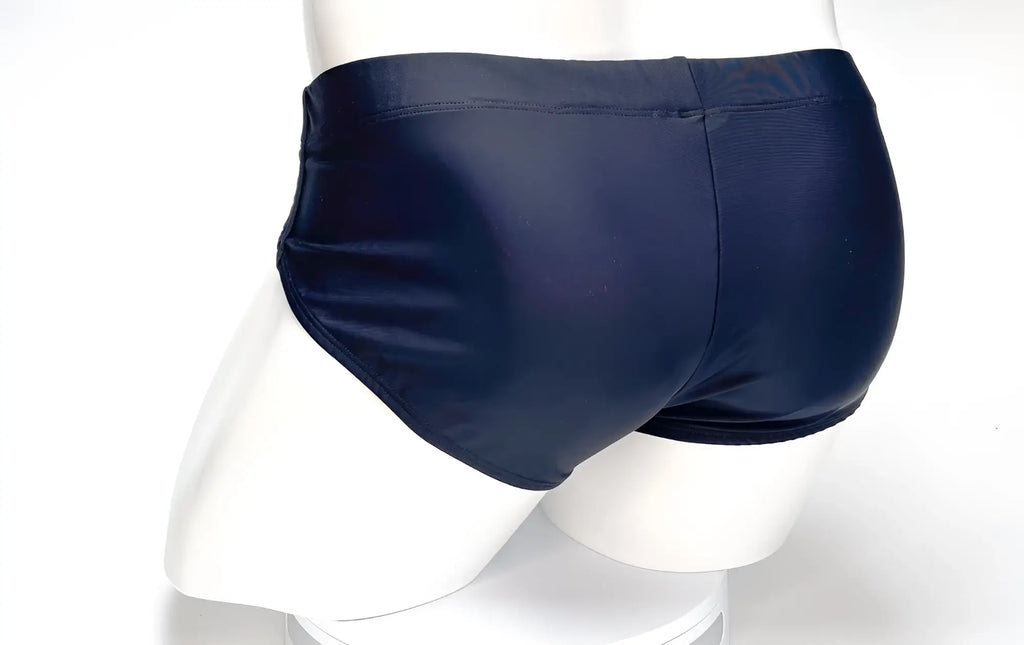 Black WildmanT swim brief featuring a snug, full-coverage fit on a white mannequin.
