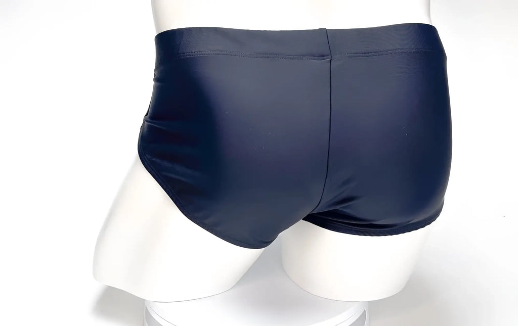 Back view of WildmanT Big Boy Pouch swim brief in smooth black fabric on a white mannequin torso.