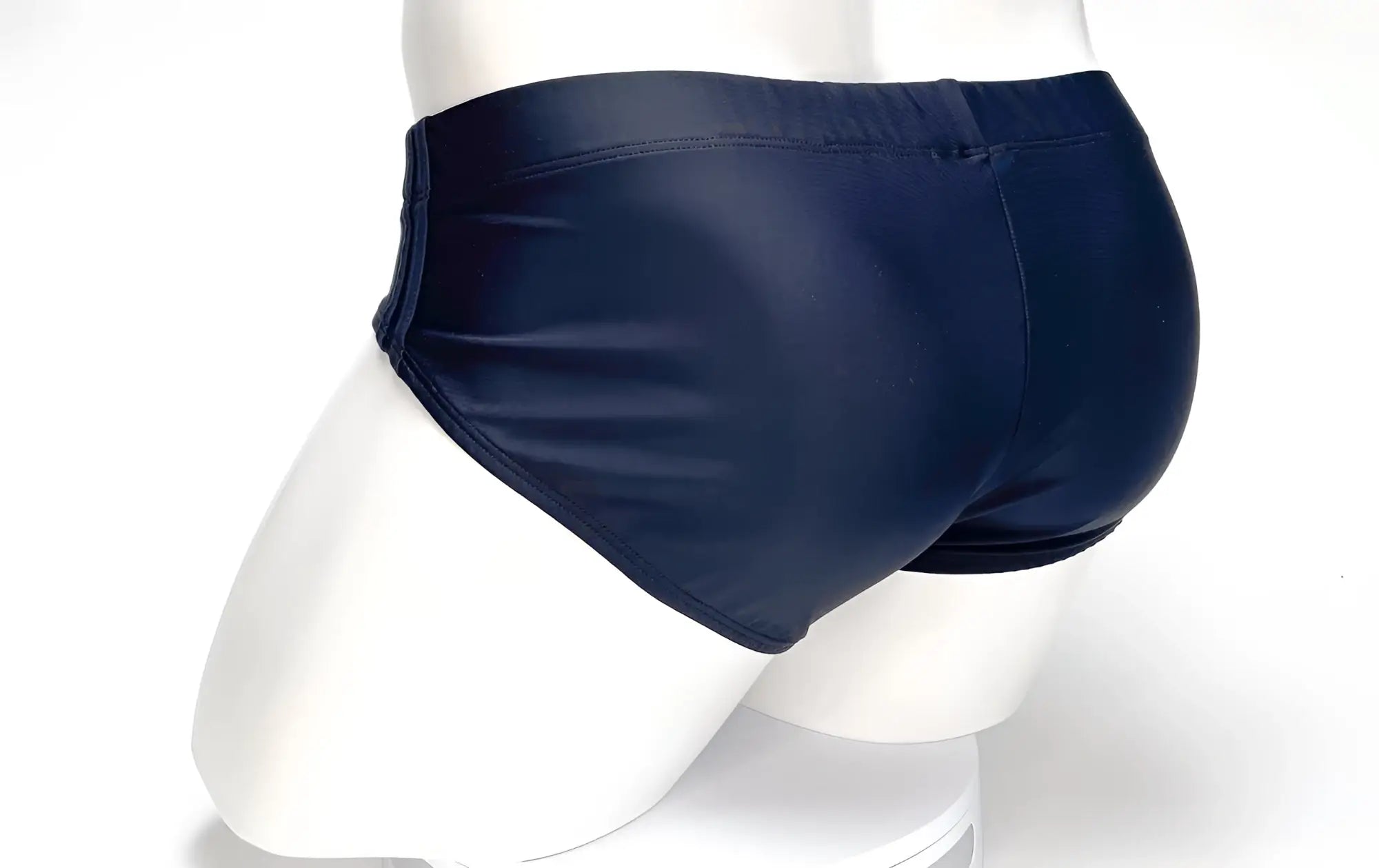 Back view of a WildmanT Big Boy black swim brief on a white mannequin torso.