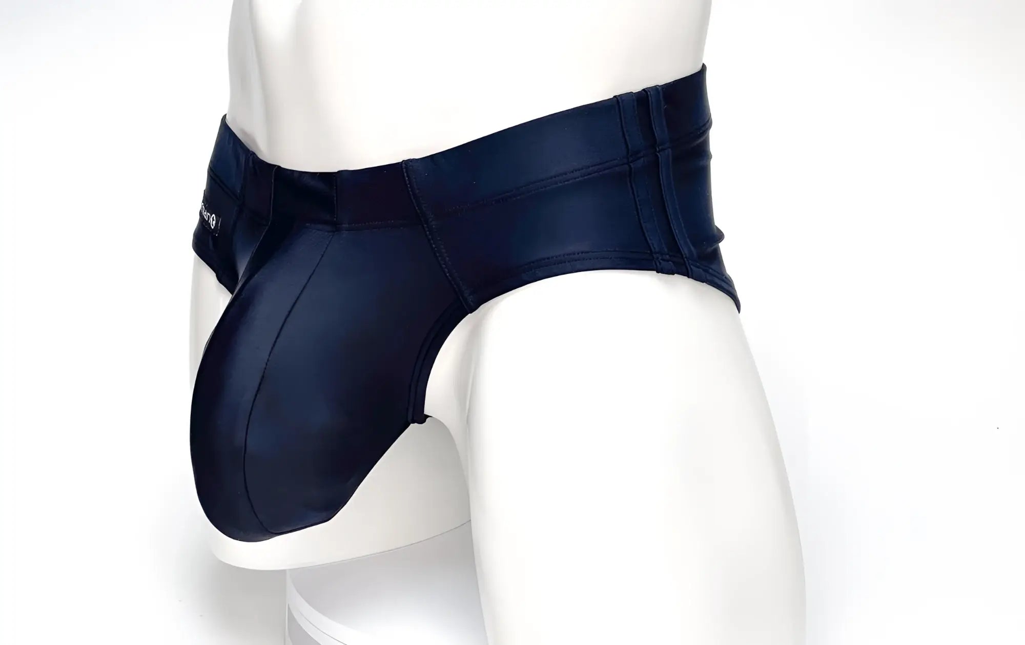 Black WildmanT Big Boy pouch swim brief worn by a mannequin, featuring a prominent contoured front pouch.