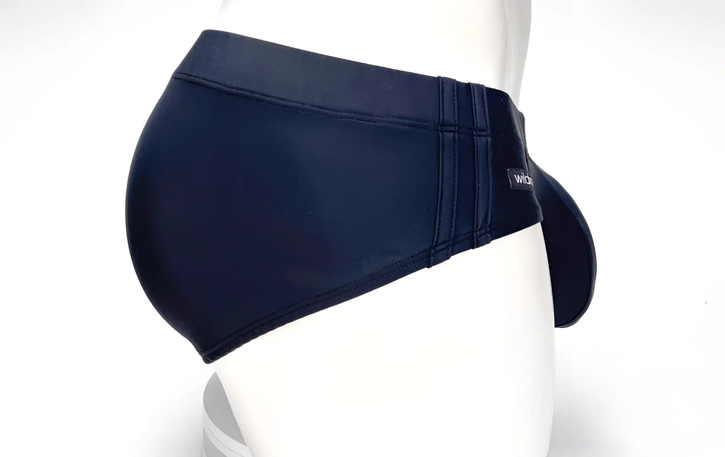 Side view of black WildmanT Big Boy pouch swim brief on a white mannequin with a prominent front pouch.