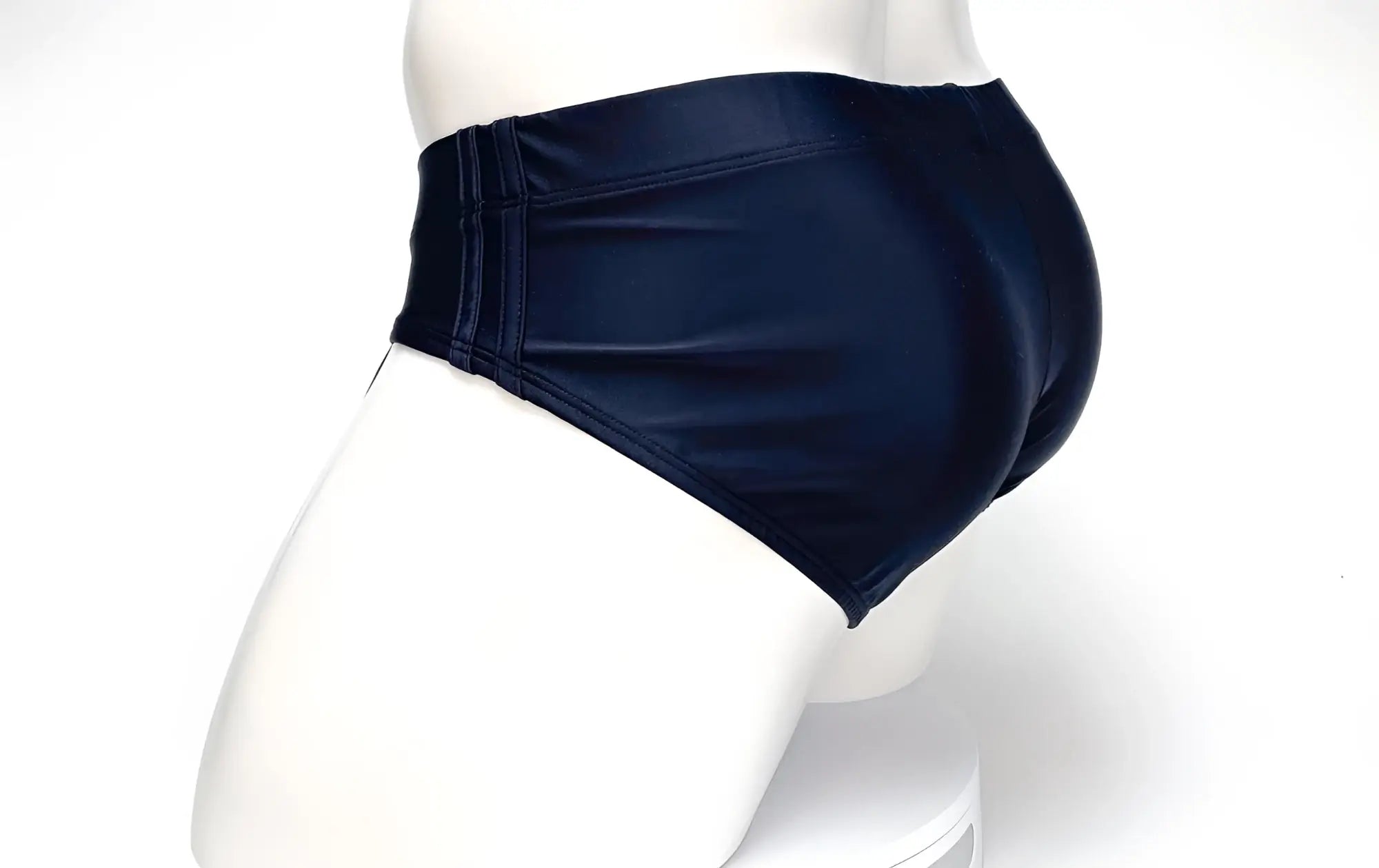 Black WildmanT swim brief with side-seam detailing on a white mannequin.