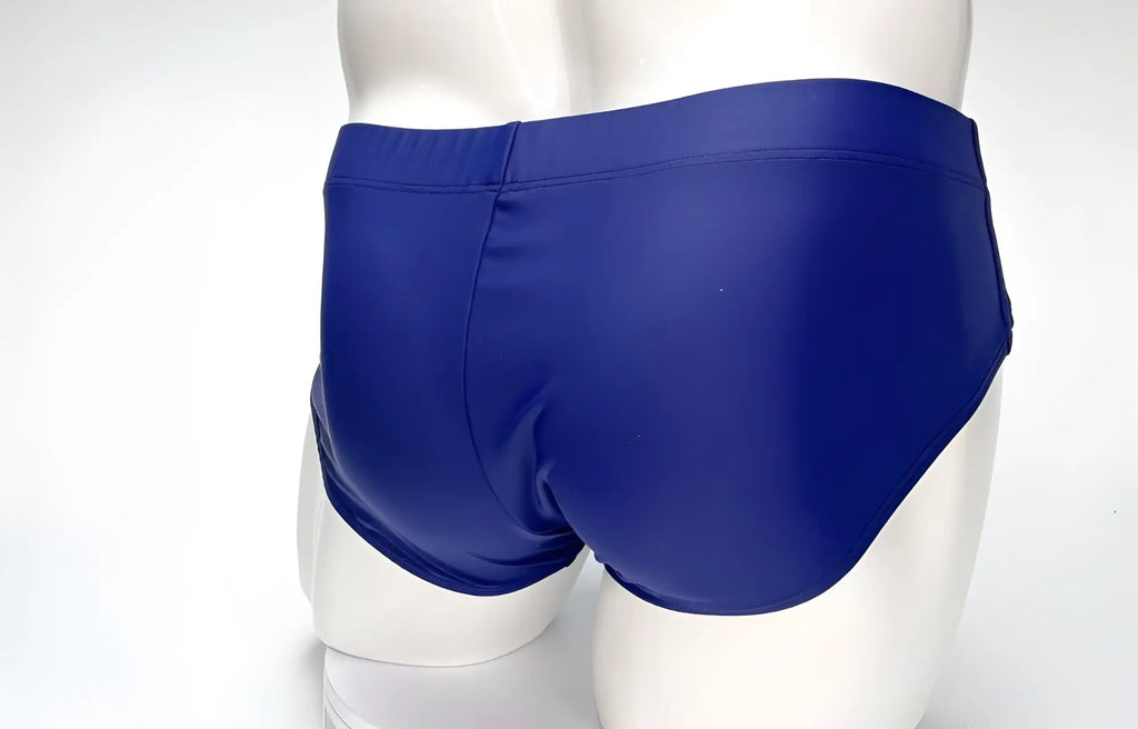 Rear view of navy blue WildmanT swim briefs on a white mannequin.