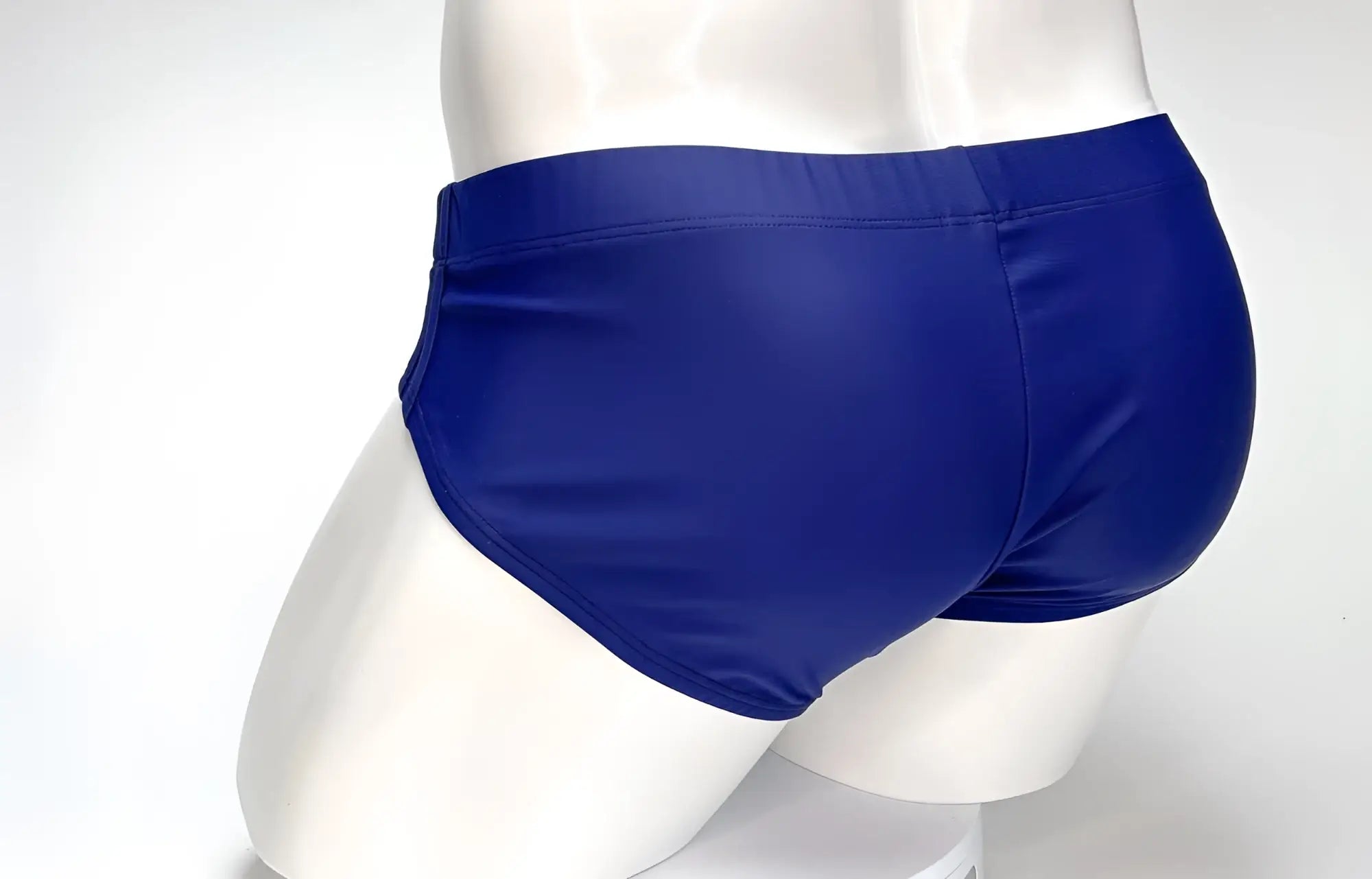 Back view of a WildmanT Big Boy navy blue swim brief on a white mannequin torso.