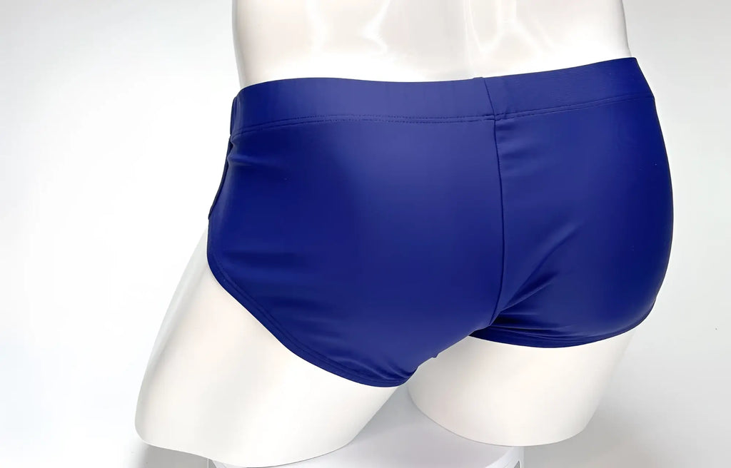 Rear view of navy blue WildmanT Big Boy swim brief on a white mannequin.