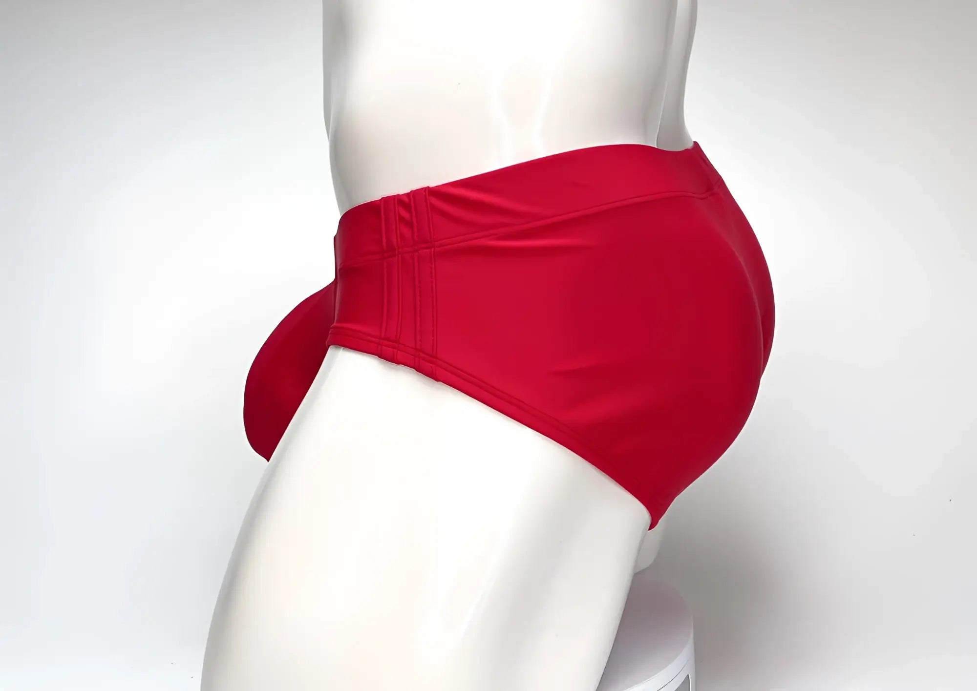 WildmanT Big Boy Pouch swim brief in bright red, shown from the side on a white mannequin.
