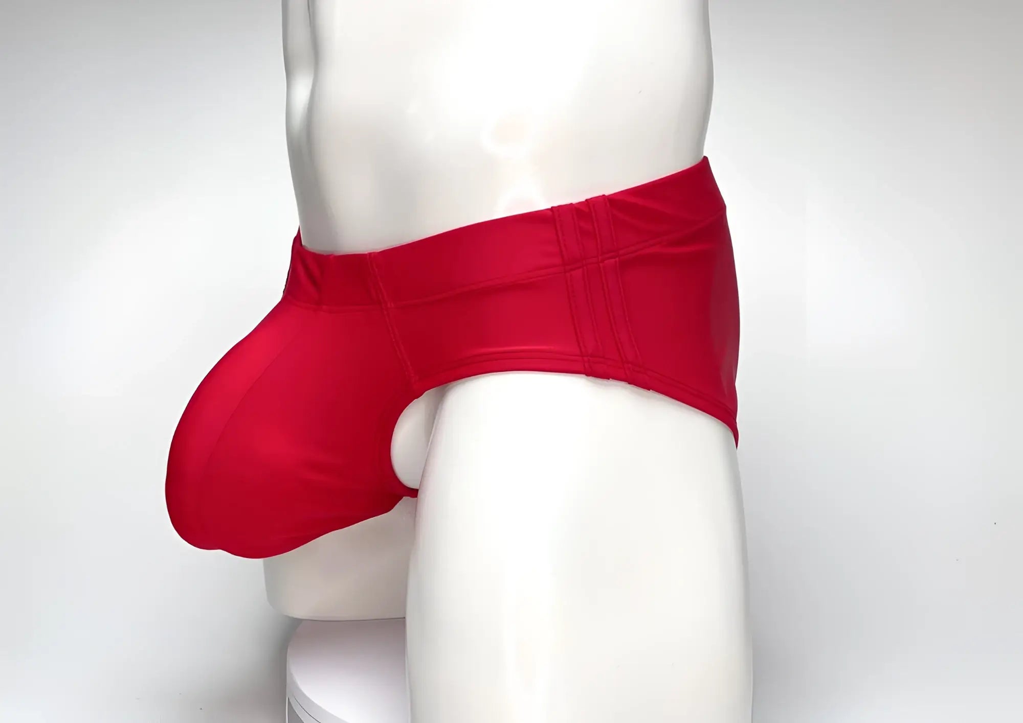 Red WildmanT Big Boy pouch swim brief worn by a mannequin, featuring a contoured front pouch and wide side panels.