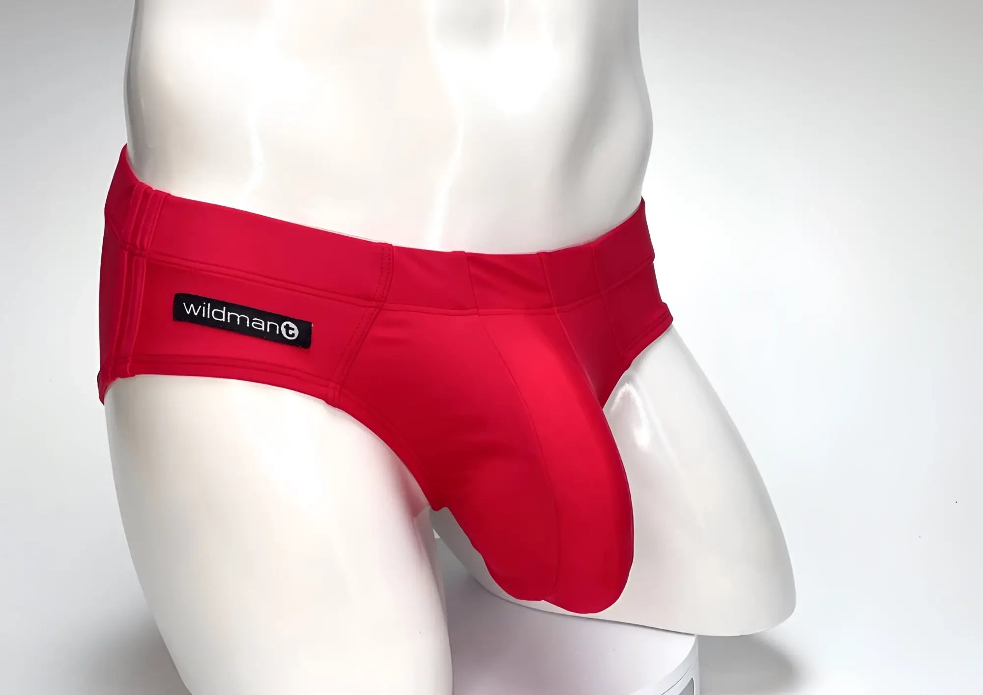 Red WildmanT swim brief with a large contoured front pouch on a white mannequin.