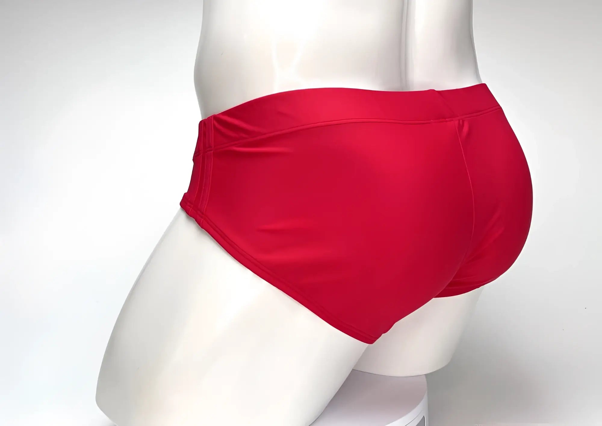 Red WildmanT Big Boy pouch swim brief shown from a rear angle on a white mannequin.