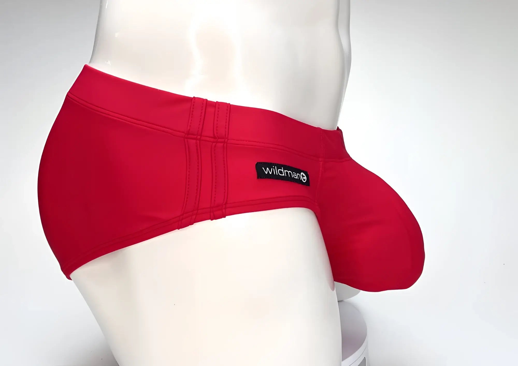 WildmanT Big Boy Pouch swim brief in red, featuring a prominent front pouch and a small side brand logo tag.