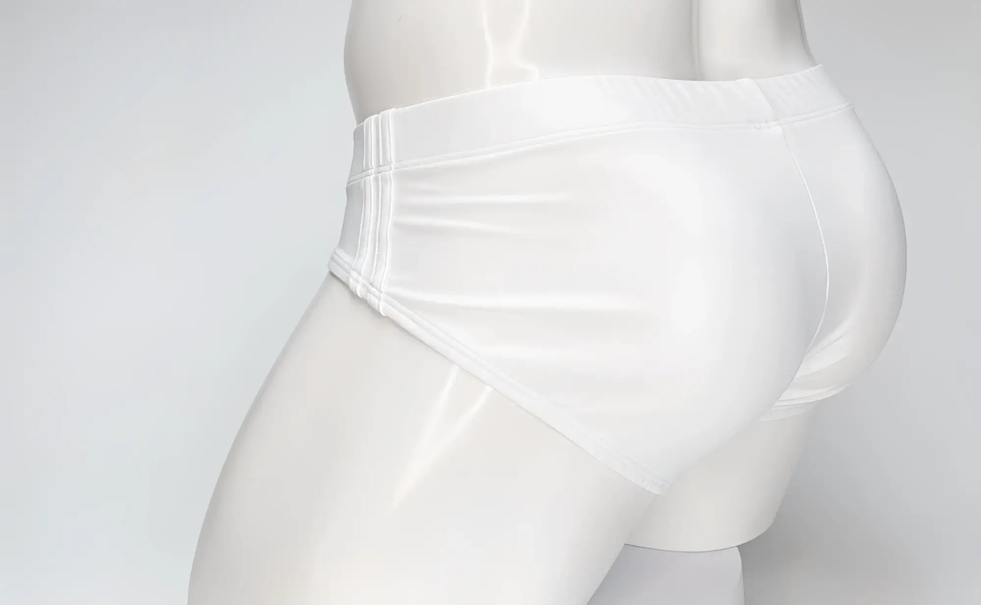 Side view of a white WildmanT Big Boy swim brief on a white mannequin, featuring stitched side panel detailing.