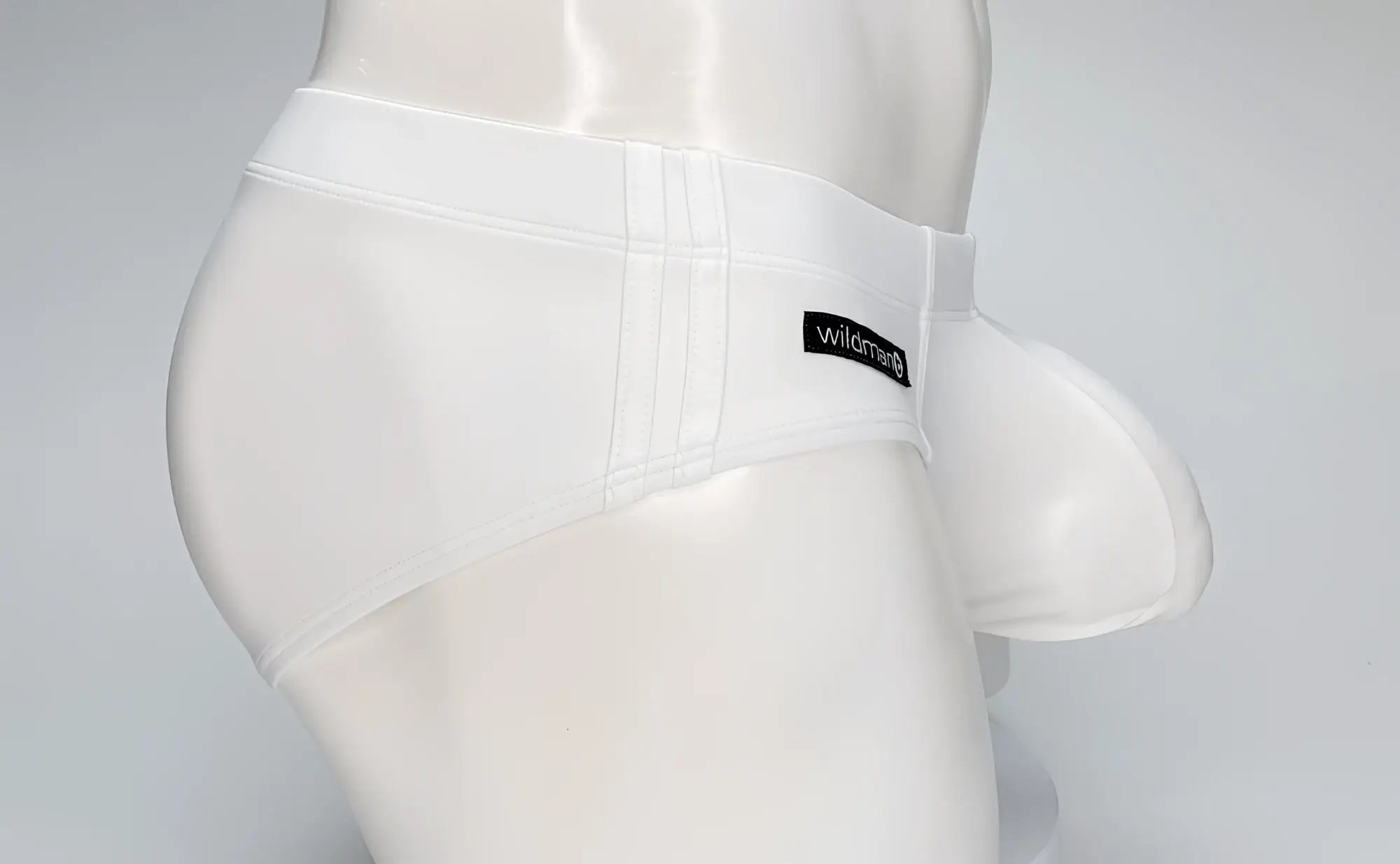 White WildmanT Big Boy Pouch swim brief on a mannequin, featuring a prominent front pouch and side stitching details.