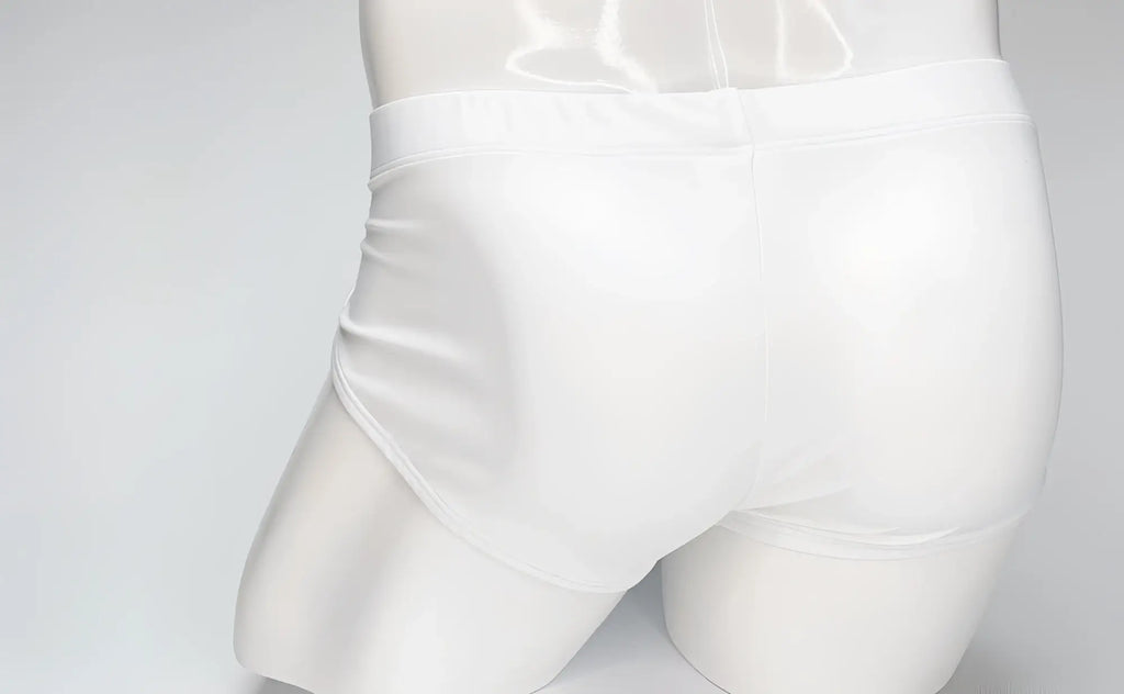 Back view of a white WildmanT Big Boy Pouch swim brief on a white mannequin torso.