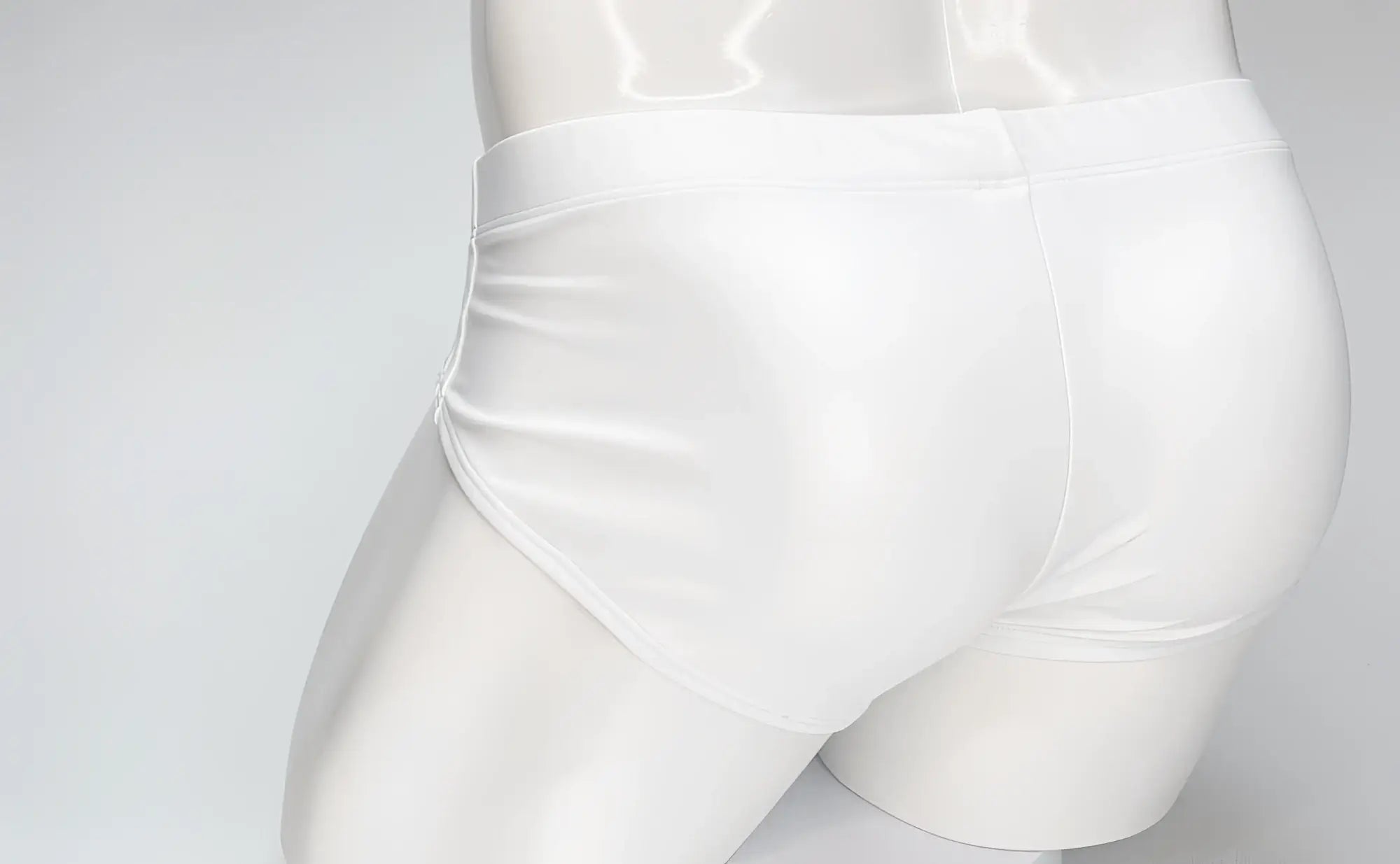 WildmanT white swim brief on a mannequin, featuring a snug fit with minimalist, sleek styling.
