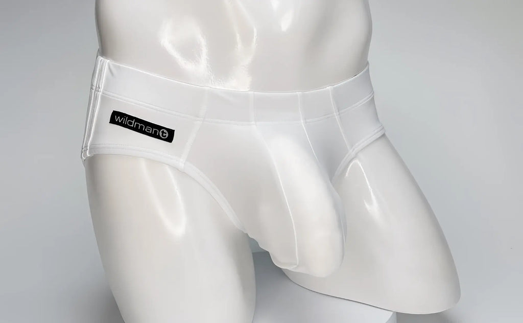 White WildmanT swim brief on a mannequin, featuring a contoured front pouch and a black branded label on the hip.