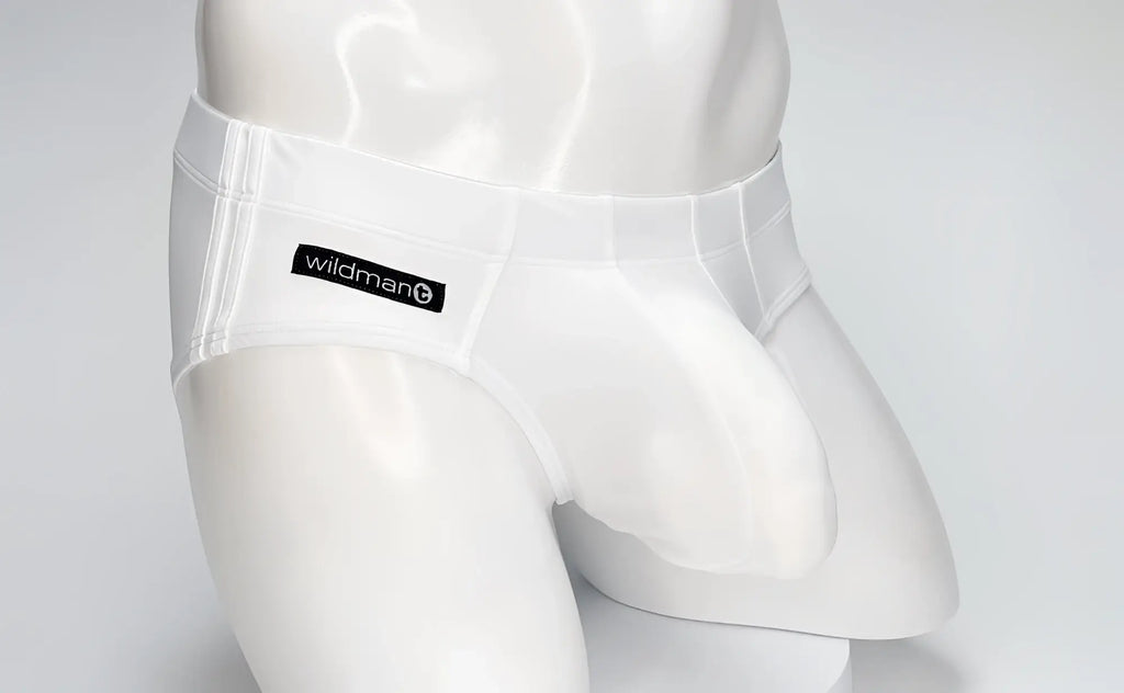 White WildmanT Big Boy pouch swim brief worn by a white mannequin, featuring a branded black logo patch.