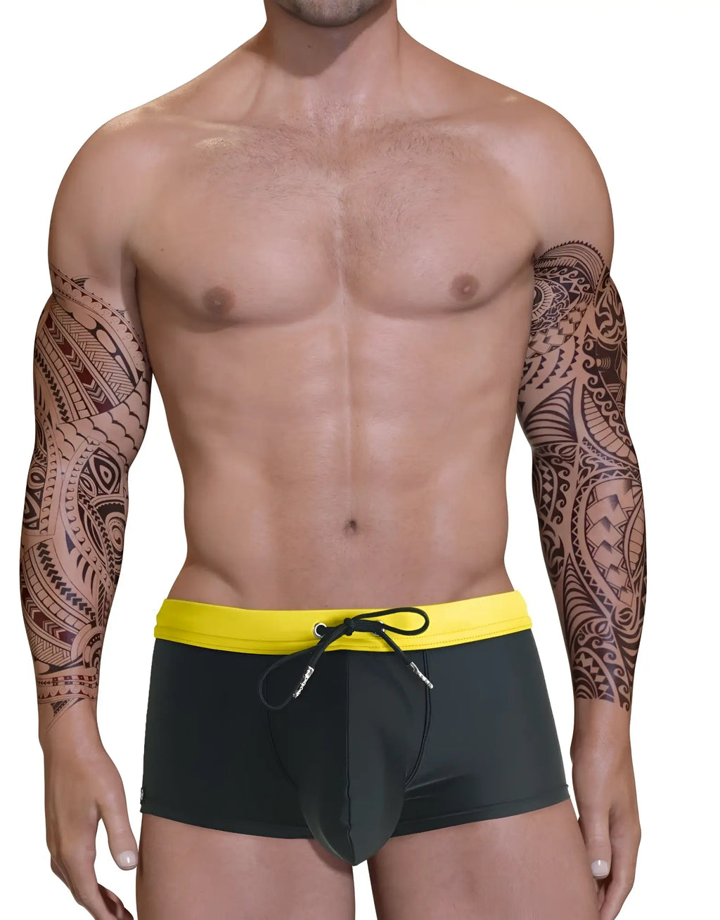 Black square-cut swim trunks with a yellow waistband, drawstring, and structured front pouch worn by a tattooed model.