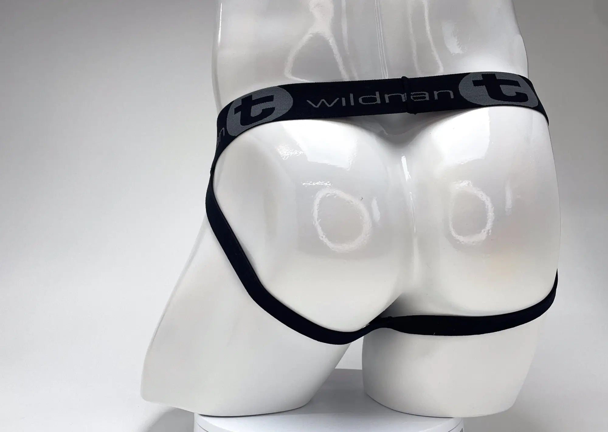 WildmanT black jockstrap with a branded elastic waistband on a white mannequin.