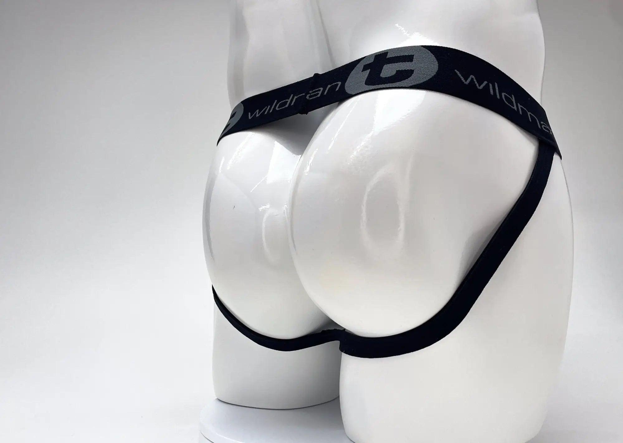 WildmanT black jockstrap with a branded waistband worn on a white mannequin.