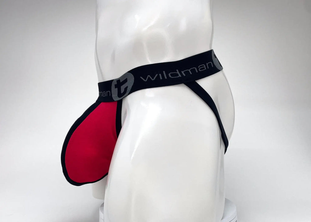 Red jockstrap with a large pouch and black waistband featuring the WildmanT logo on a white mannequin torso.