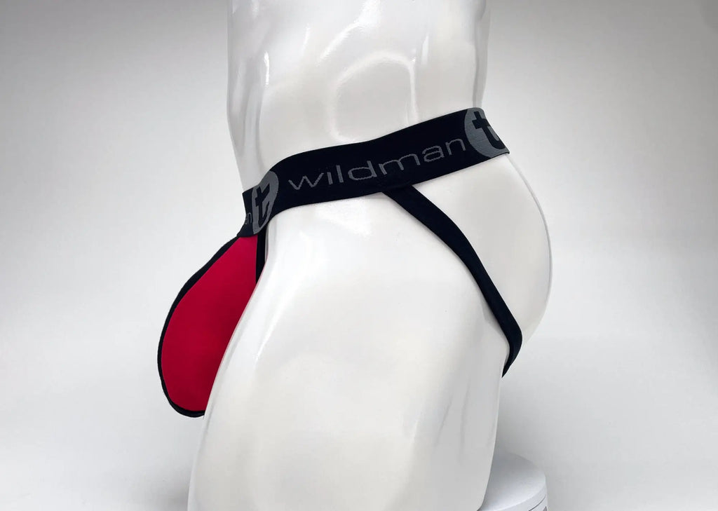 Red and black jockstrap with a large, contoured front pouch and a black waistband featuring the "WildmanT" logo.