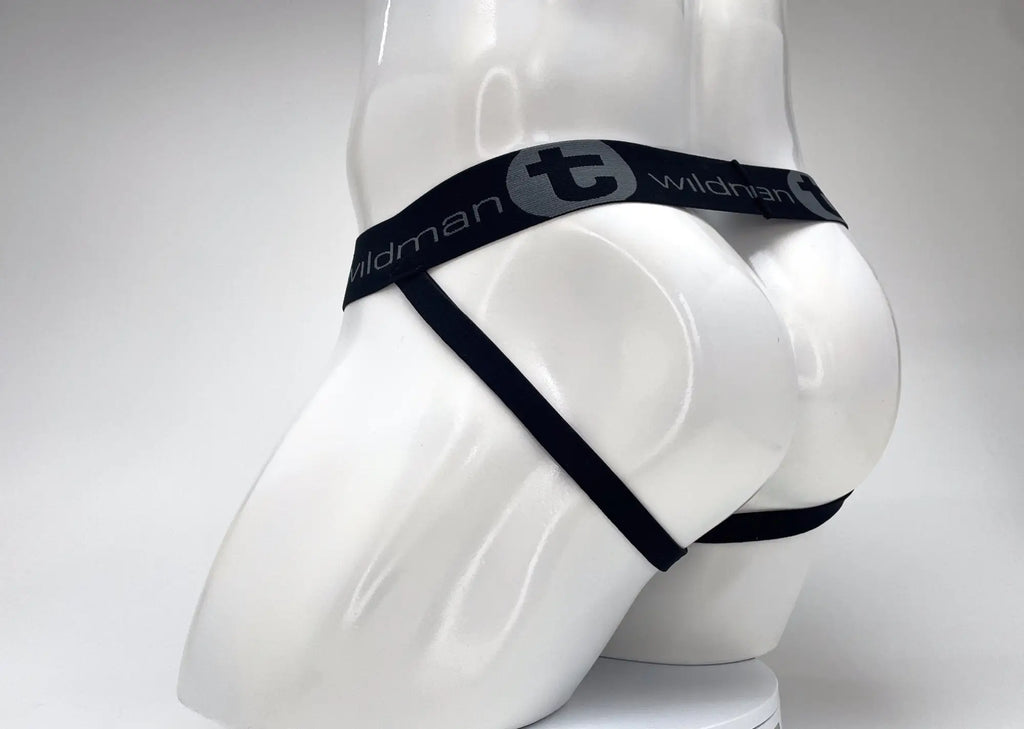 WildmanT jockstrap on a white mannequin, featuring a black branded elastic waistband and thin black leg straps.